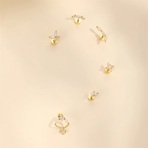 Macro detail of 925 sterling silver opal heart earrings with gold plating and zircons