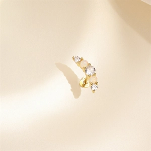 Close-up of golden curved cartilage stud featuring opal and cubic zirconia stones