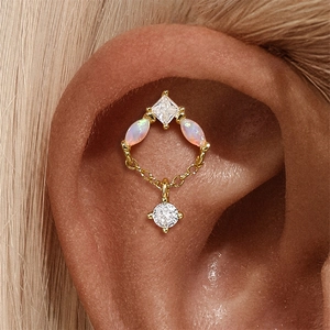 Detail of 925 sterling silver opal heart piercing with marquise cut stones and chain