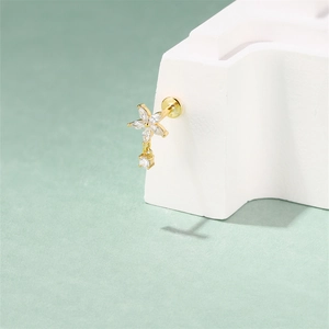 Close-up of gold flower labret stud with marquise pink opal and cubic zirconia stones