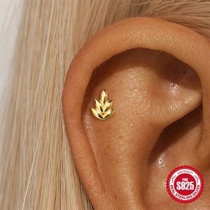 Elegant gold S925 sterling silver flame shaped stud earring worn on the ear bone