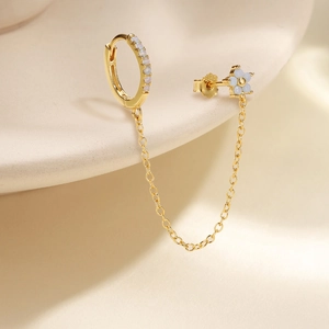 Detail of S925 silver flower stud with sparkling zircon drop and delicate link chain