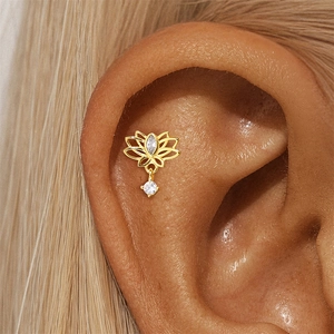 Macro view of gold lotus stud earrings with marquise pink opal and zircon on ear