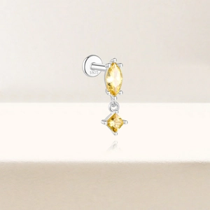 Macro shot of S925 sterling silver earring featuring yellow marquise and square cut stones