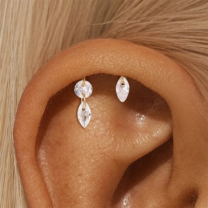 Macro shot of gold marquise pink opal earrings set with sparkling stones on model