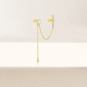 Detailed macro view of S925 sterling silver gold-plated chain earring with zircon stones