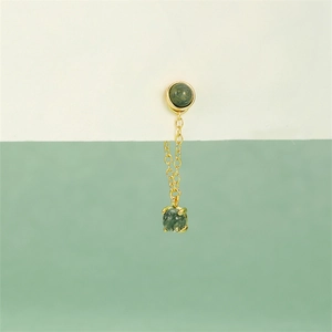 Detail of a gold S925 silver earring with cross chain and green moss agate stone charm