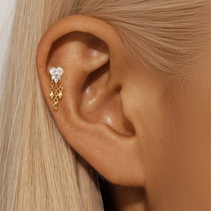 Macro detail of S925 silver gold ear stud with opal, moon and star charms on model