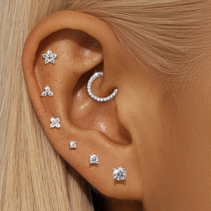 Close-up of S925 silver moissanite cartilage piercing stud set on model ear