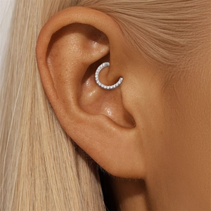 Detail shot of a s925 silver Daith ring with shimmering pavé set cubic zirconia stones