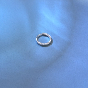 Close-up of S925 sterling silver piercing hoop with micro-paved moissanite stones
