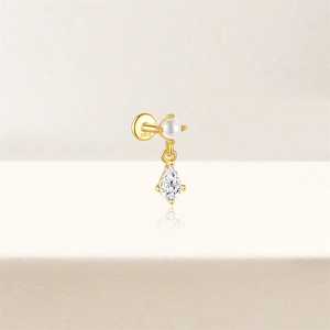 Macro detail of S925 sterling silver ear stud with round pearl and teardrop gemstone