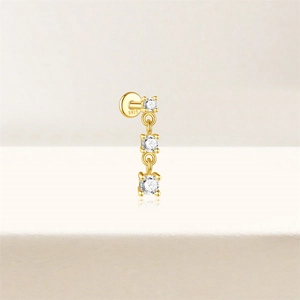 Close-up of S925 silver gold-plated stud earring with three vertical sparkling zircons