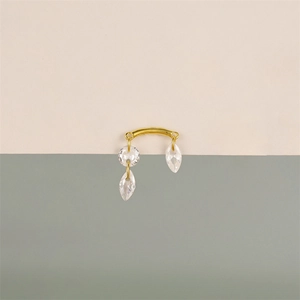 Detail showing 925 sterling silver stamp on gold navel ring with crystal clusters