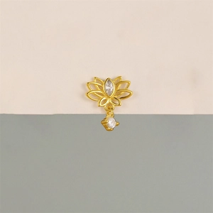 Detailed view of a golden lotus piercing stud with marquise and round zircon dangles