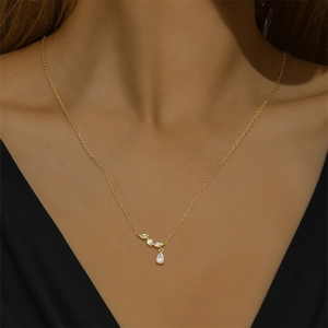 Macro shot of S925 silver necklace with teardrop and marquise gems on neck