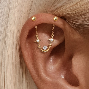 Close-up of gold plated S925 silver ear cuff with moon, stars and zircon chain details