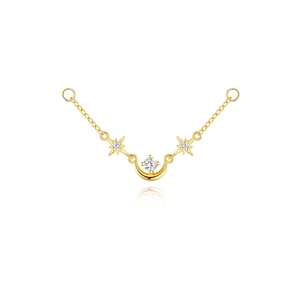 Macro detail of gold celestial star and moon charm connector with diamond accents