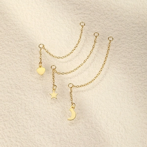 Detailed view of long gold star moon and heart pendant chain earrings for women