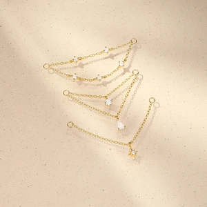Detailed view of 18K gold plated S925 silver chains with zircon charms and star pendant
