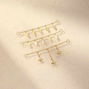 Macro shot of three S925 sterling silver golden chain pendants with zircon charms