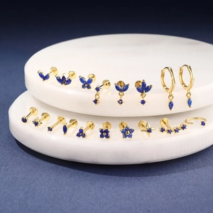 Macro shot of S925 sterling silver stamp on gold earrings with blue lapis lazuli