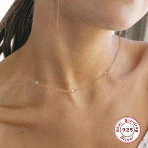 Elegant S925 sterling silver gold necklace featuring three sparkling bezel-set zircons