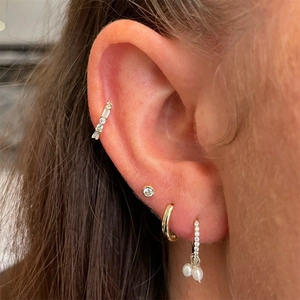 Détail de boucles d'oreilles cœur en argent S925 avec glands, diamants et perles