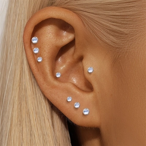Close-up of S925 sterling silver moonstone studs worn on earlobes and cartilage