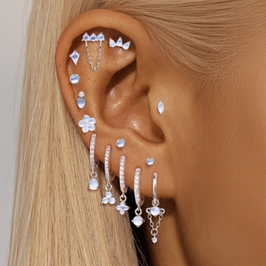 S925 sterling silver ear piercing set featuring natural moonstones on a female model