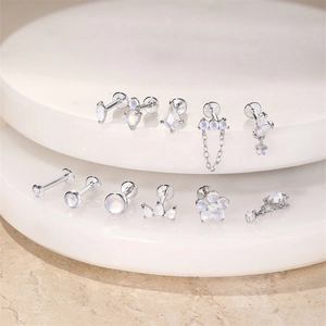 S925 sterling silver moonstone stud earrings displayed on elegant white round platforms