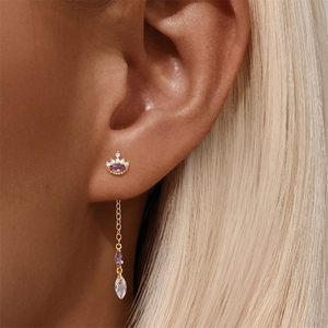 Macro shot of S925 sterling silver ear stud with crown design and purple crystal drop