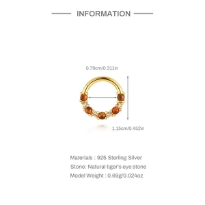 Macro detail of gold plated s925 silver hoop with tiger eye and amethyst stones