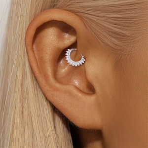 Close-up of S925 silver ear cartilage stud with 11 sparkling moissanite stones on ear