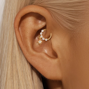 Close-up of golden S925 silver star cartilage hoop with cubic zirconia on a model