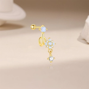 Detail view of gold s925 silver sunflower stud with blue opal and dangling zircon stone