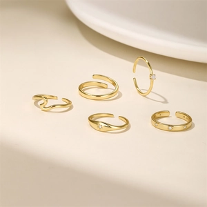 Detailed view of S925 sterling silver gold rings set featuring star and wave designs