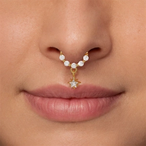 Golden opal nose ring with zircon pentagram star pendant shown on a model's nose