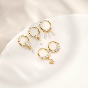 Close-up of gold plated S925 silver hoop earrings with marquise stones and star charms