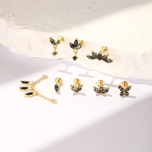 Detailed macro shot of S925 sterling silver gold earrings with black marquise gemstones