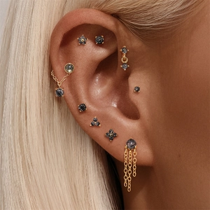 Detail of s925 silver ear studs featuring rutilated quartz and crown flower motifs