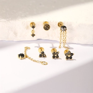 Macro detail of S925 silver jewelry set featuring black rutilated quartz and gold plating
