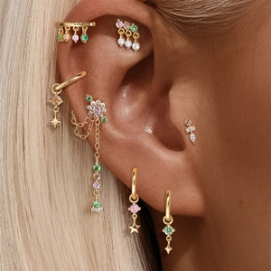 Detailed close-up of golden S925 silver dinosaur earrings with colorful cubic zirconia