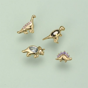 Detailed view of gold S925 silver dinosaur studs set with colorful zircon stones