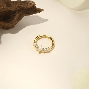 Detail of S925 silver gold-plated hinged hoop featuring marquise and round cut zircons