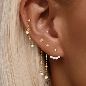 Detailed close-up of S925 silver star and moon tassel earrings with white opal stones