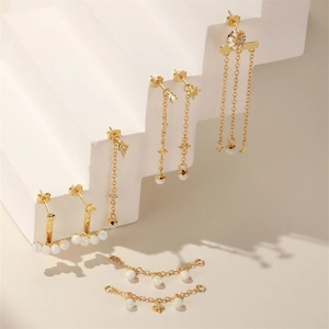 Detailed view of gold S925 silver opal earrings with celestial stars and moon chains