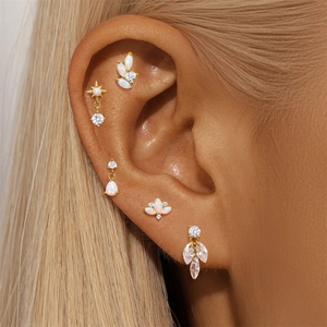 Detailed view of S925 silver bow stud earrings with opal and zircon on ear model