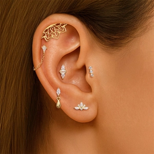 Macro shot of a 6-piece gold ear stack featuring zircon studs and opal cuff earrings