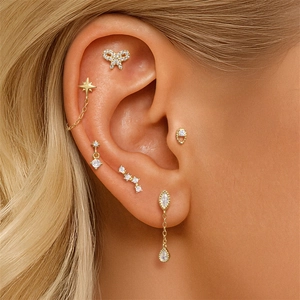 Close-up of S925 silver bow and star stud earrings set with opal and cubic zirconia